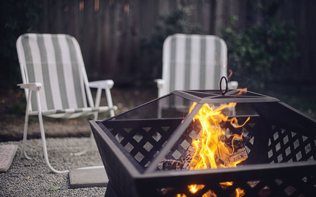 Two folding chairs by a fire