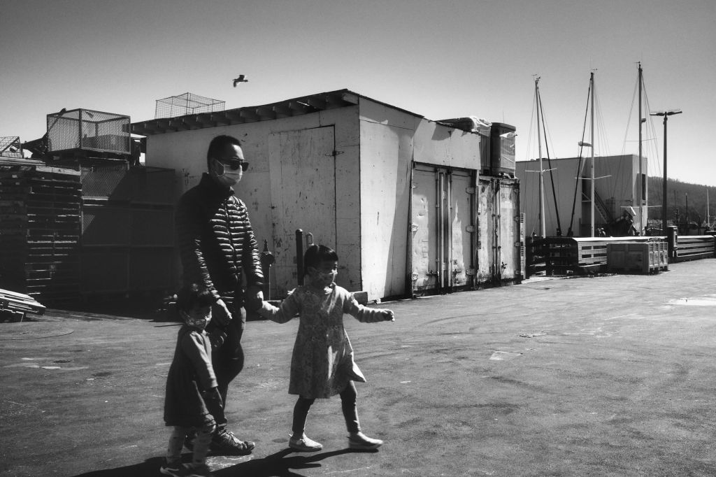 Family walking towards pier edge