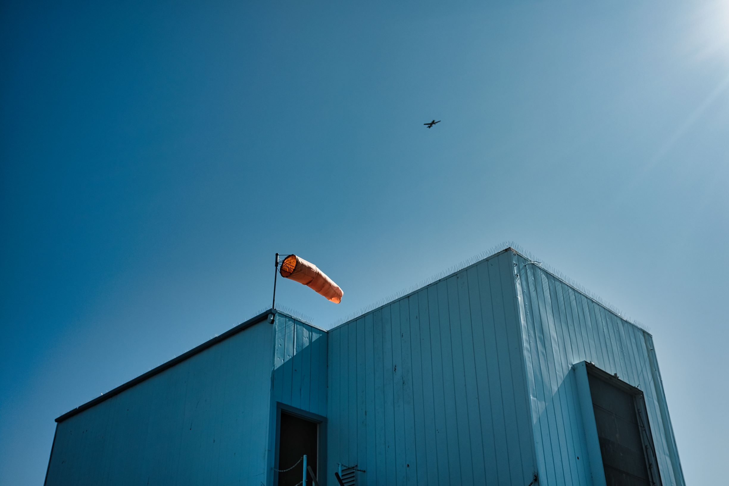 Plane passing a building