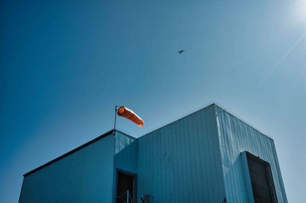 Plane passing a building
